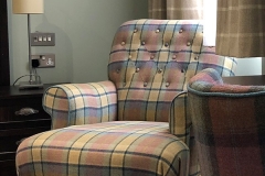 A tartan armchair in a bedroom