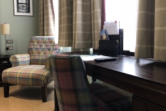 A desk and armchair in one of our rooms