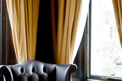 A deep buttoned leather armchair in our Suite