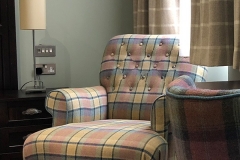 A tartan armchair in one of our rooms