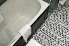Bath and patterned tiled floor in one of our bathrooms