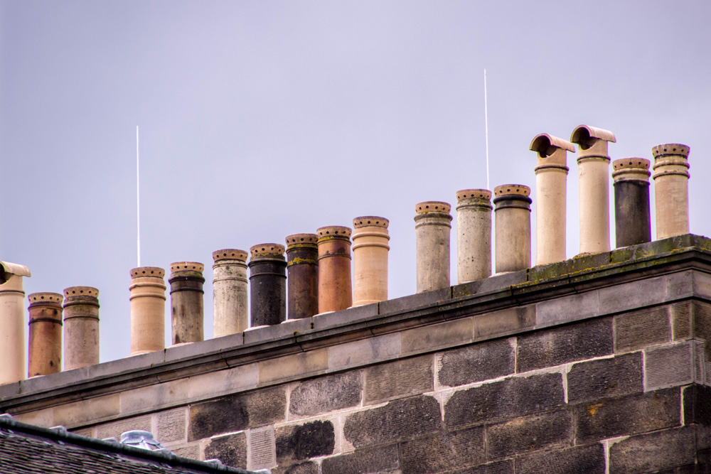 Old style chimney pots on a roof in Edinburgh