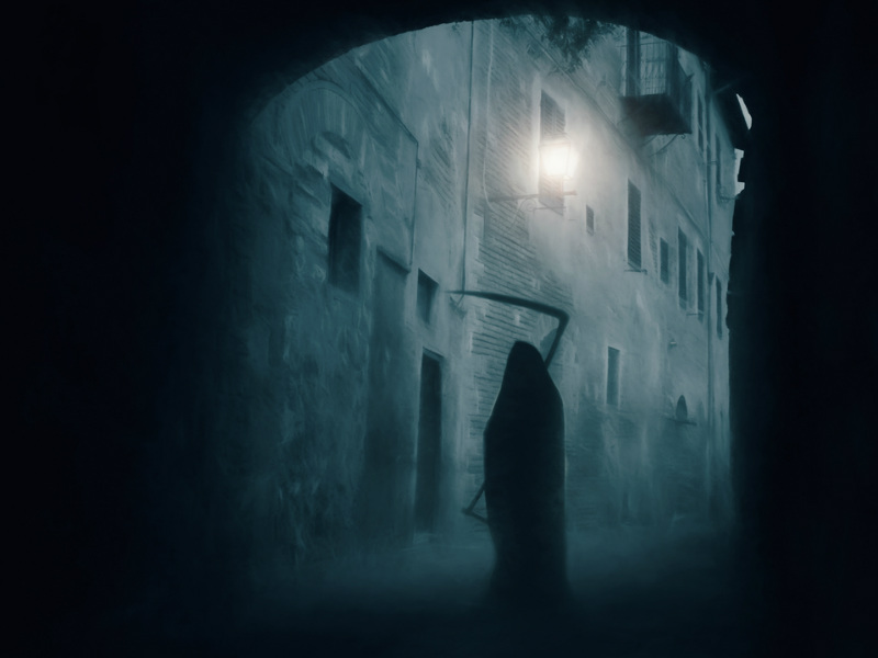 The outline shadow of the grim reaper standing in a doorway