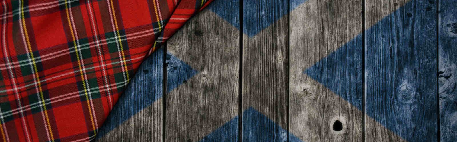 Scottish flag painted on wood and tartan cloth in the corner