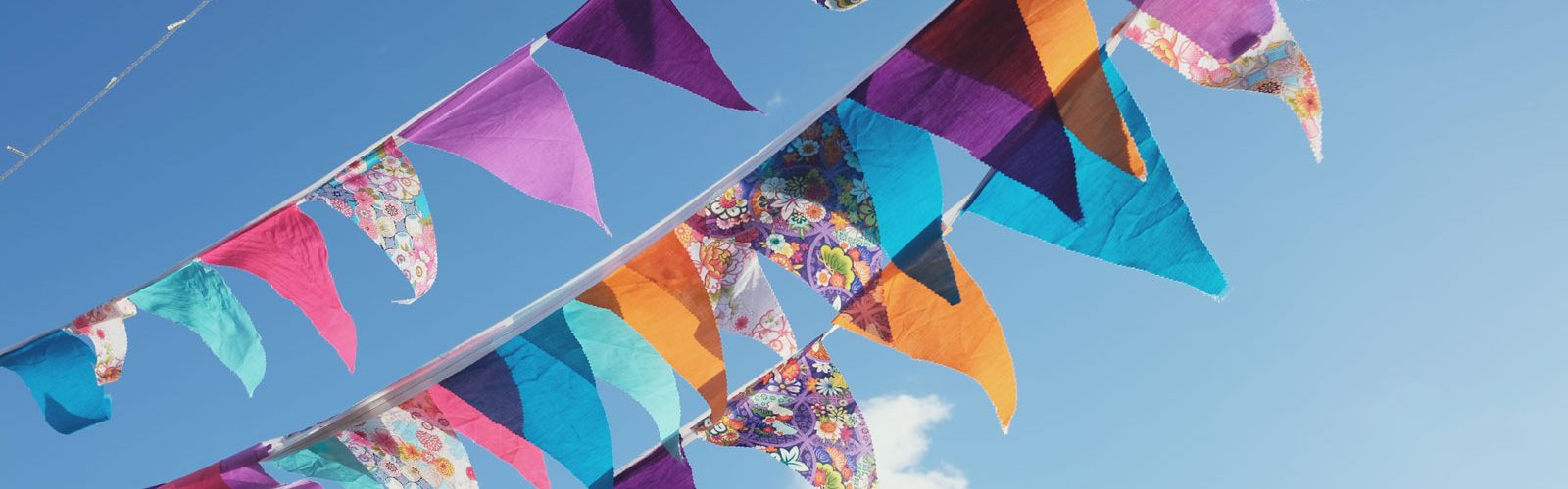 Colourful bunting against a blue summer sky