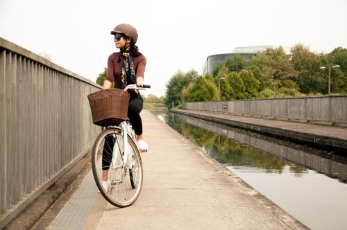 Woman cycling along the Union Canal in Edinburgh