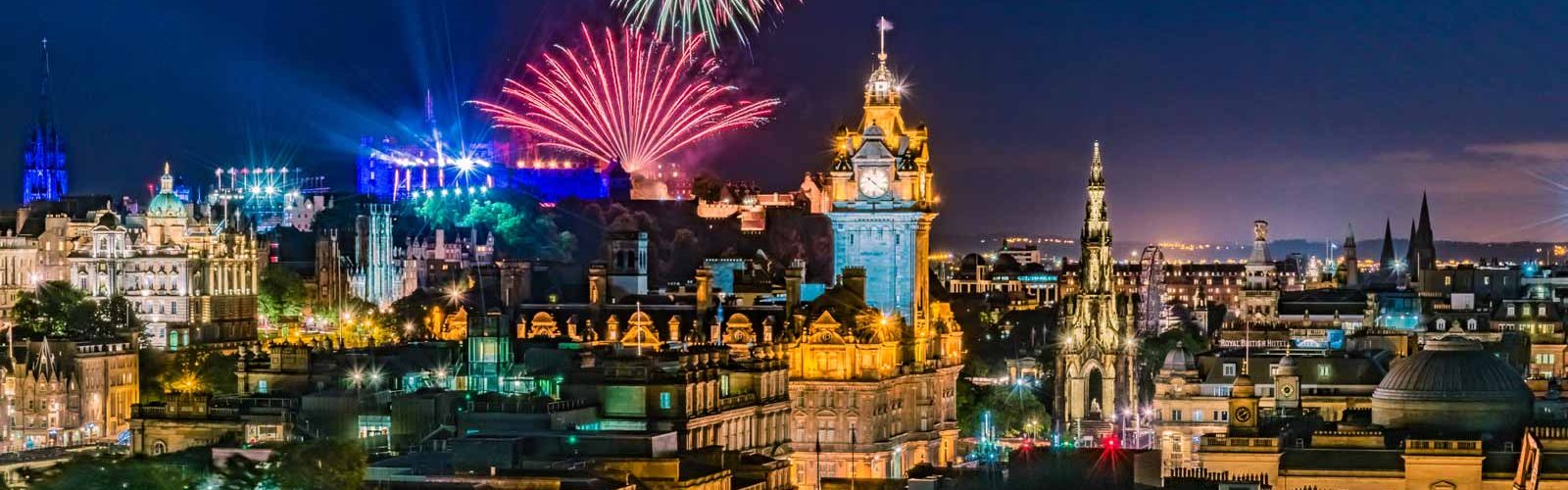 City of Edinburgh at night with Festival Fireworks in the sky
