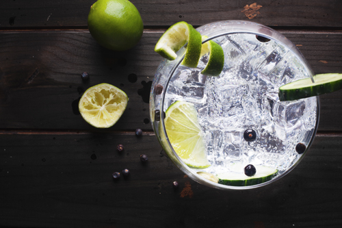 Glass of gin and tonic from above with lemon and lime
