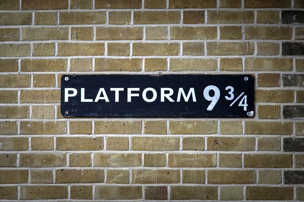 Platform 9 and three quarters sign on statiom wa;ll