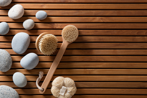 zen pebbles set on Turkish bath wooden board with exfoliating body brushes