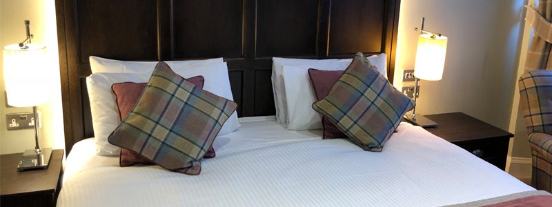A double bed in a double room at Parliament House Hotel