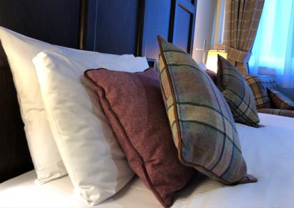 A close up of cushions on a bed in a room at Parliament House Hotel