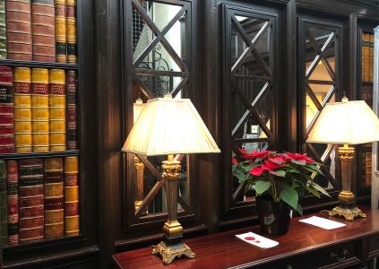 A bookcase with lamps on it at Parliament House Hotel in Edinburgh