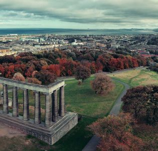 A birds eye view looking down on Calton Hill in Edinburgh with the National Monument in the foreground