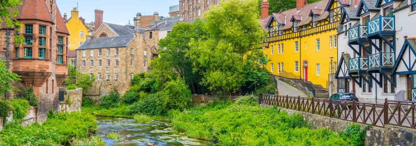 The Water of Leith running through the colourful building's of Dean Village in Edinburgh