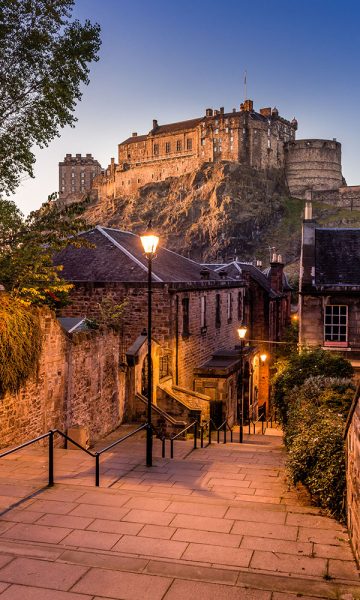A view of Edinburgh Castle from a narrow old street on a hill