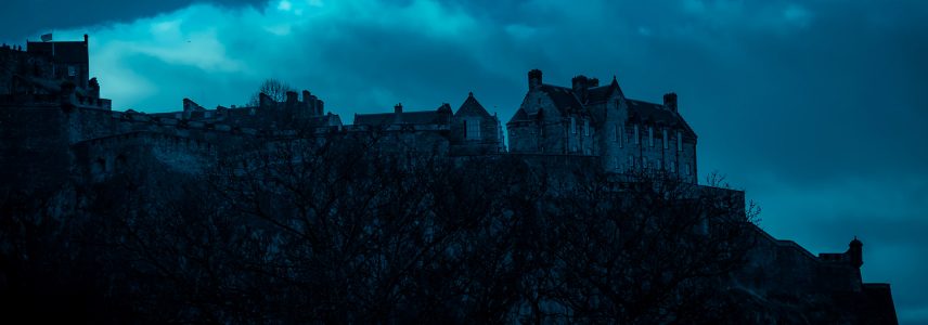 A spooky darkened silhouette of Edinburgh Castle at night