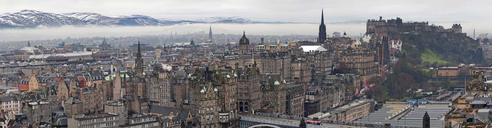 The city of Edinburgh on winters day with snow capped hills in the background