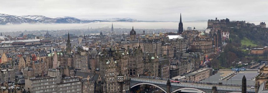 The city of Edinburgh on winters day with snow capped hills in the background
