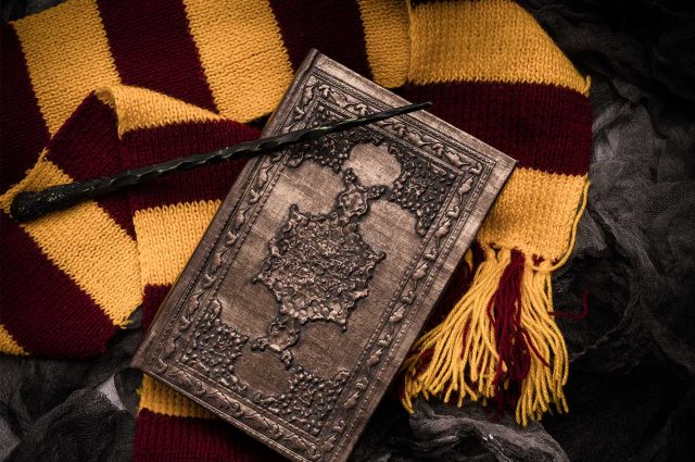 A Harry Potter scarf with a spell book and wand