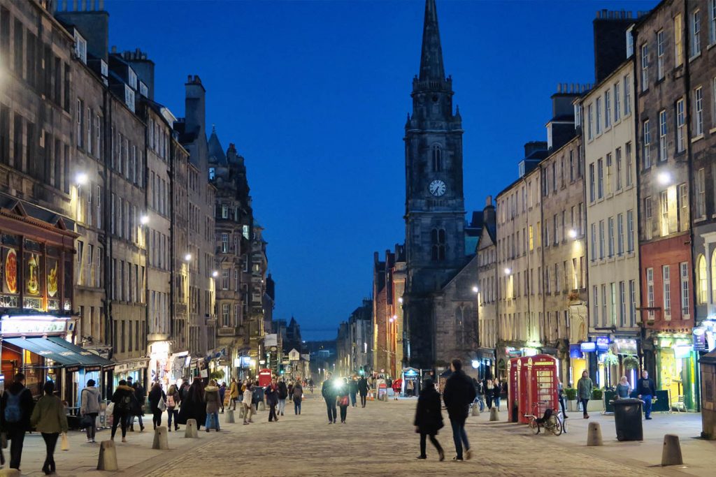 The Royal Mile at night with shoppers on the street in Edinburgh