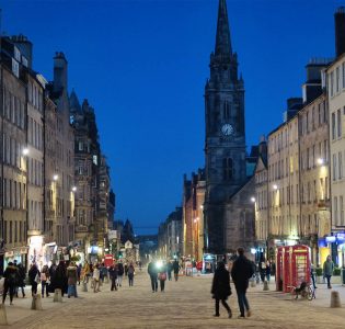 The Royal Mile at night with shoppers on the street in Edinburgh
