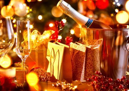 Champagne and gifts on a table set for festive dining