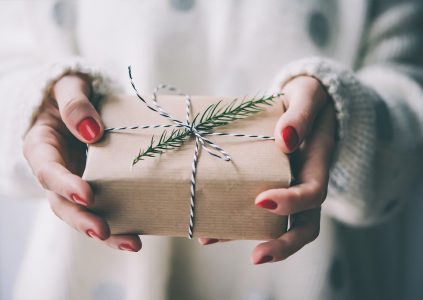 A woman holding a wrapped gift