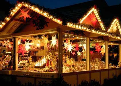 A lit up Christmas market stall