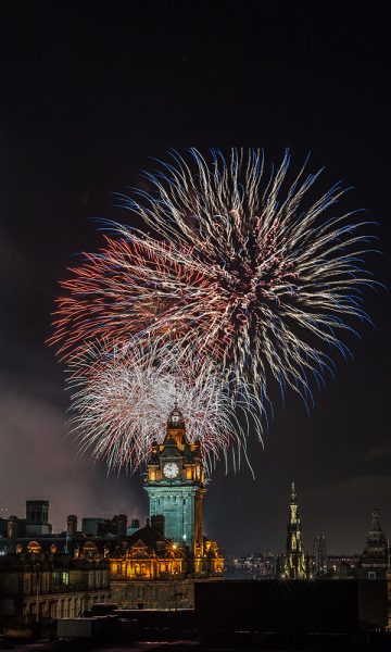 Fireworks behind The Balmoral Hotel in Edinburgh on New Years Eve