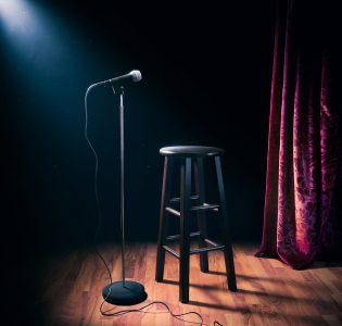 A microphone and stool on a stage