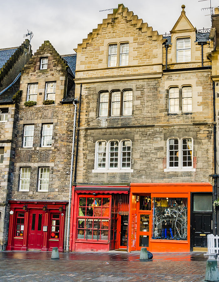 The colourful shops and old buildings in the Grassmarket Edinburgh