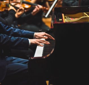 A pianist playing with an orchestra