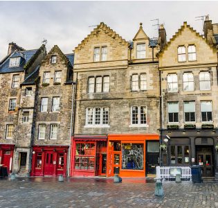 Colourful shops and pubs in the Grassmarket in Edinburgh