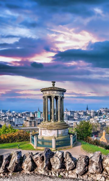 The Burns Monument with the city of Edinburgh in the background on Calton Hill