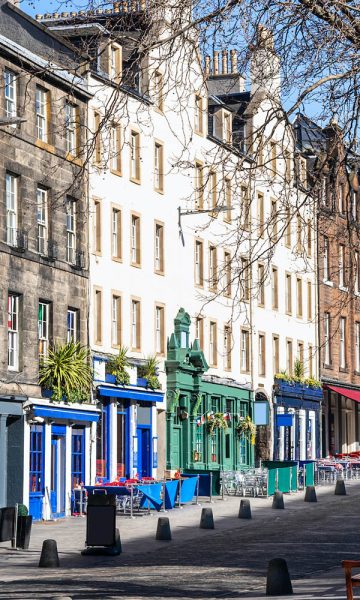 Colourful cafes and shops and the old buildings in the Grassmarket Edinburgh