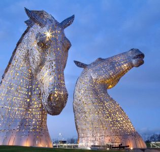The Kelpies lit up in early evening