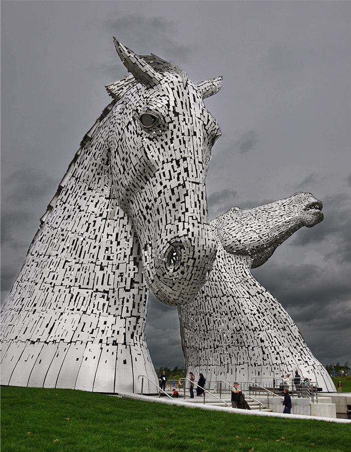 The Kelpies at Falkirk with a dark dramatic sky behind them
