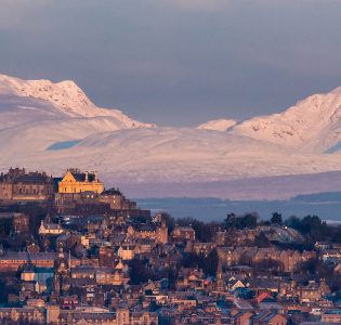Stirling City and Stirling Castle with snowy hills in the background