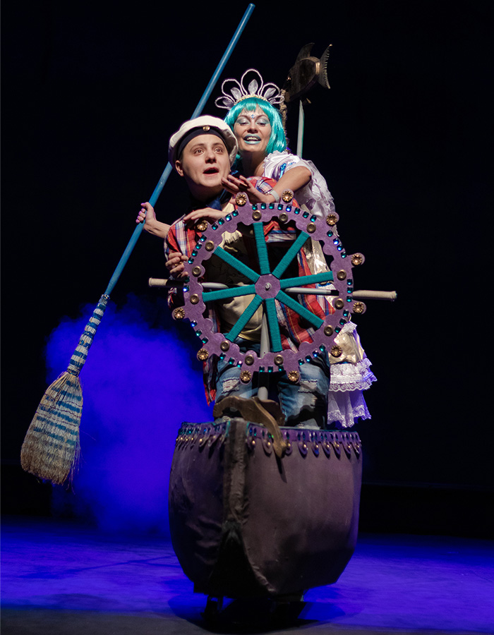 Two actors in a pantomime on a boat on the stage