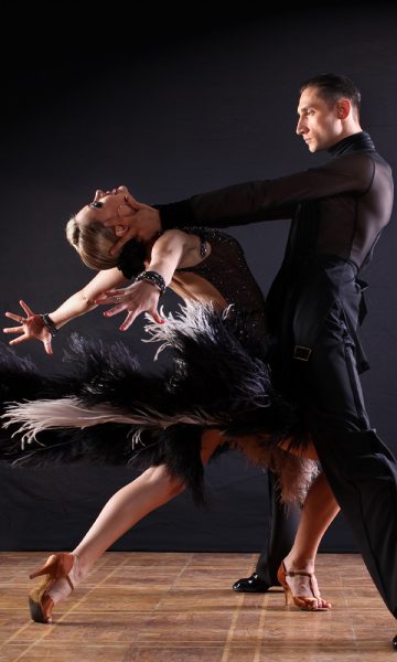 Two ballroom dancers performing a dramatic dance together