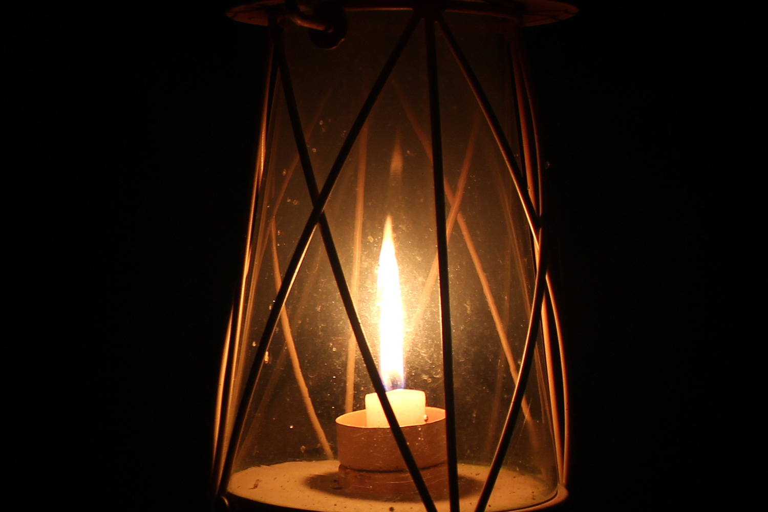 Old lantern burning in dark room
