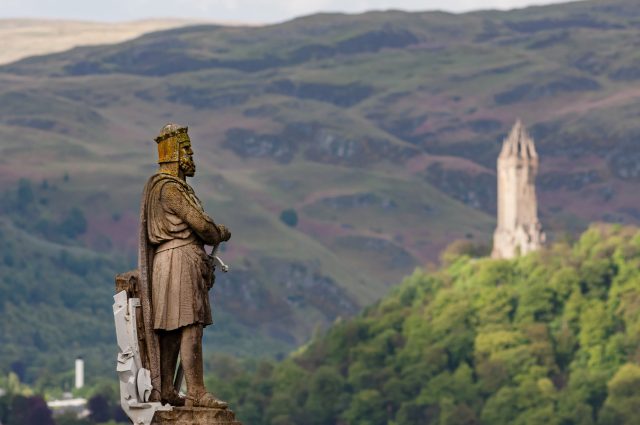 Statue of Robert The Bruce in Stirling with Wallace Monument in background