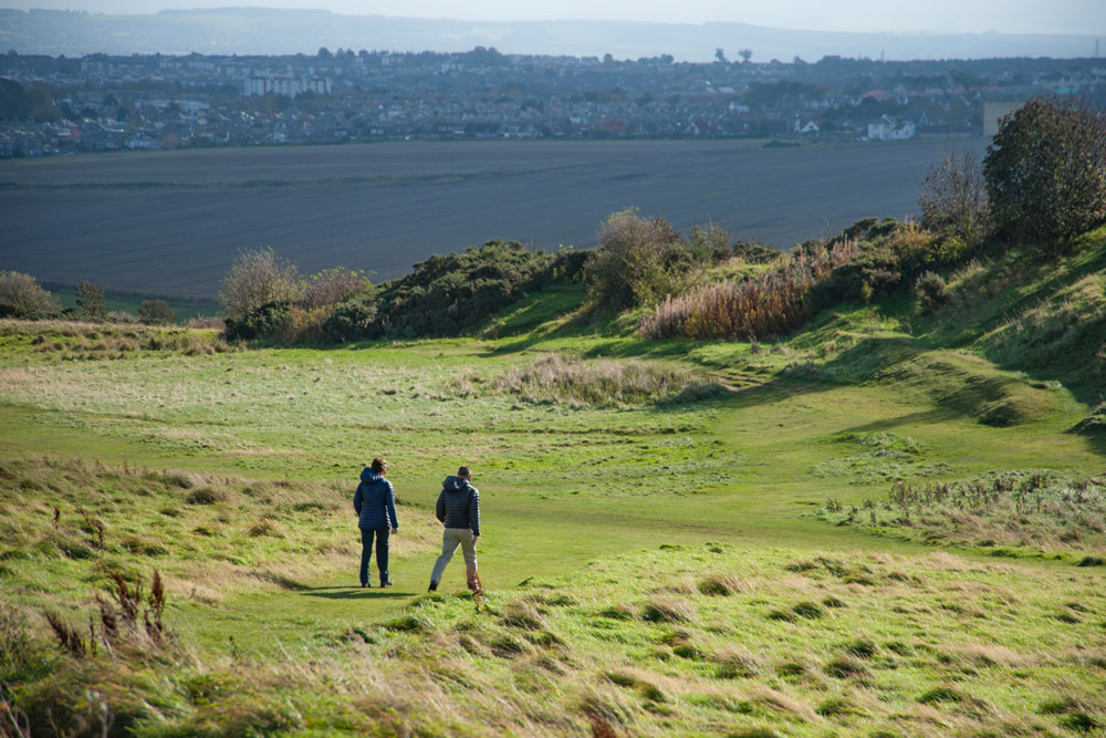Two men walking at the top of Blackford Hill in Edinburgh