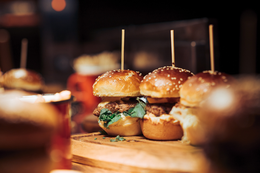 Burgers on a wooden board in a pub