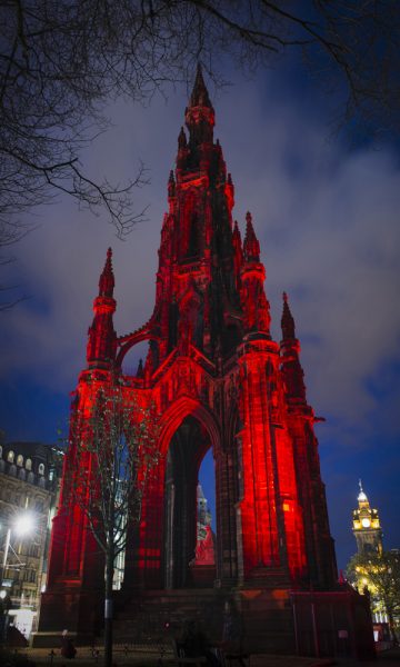 Scott Monument lit up red at night
