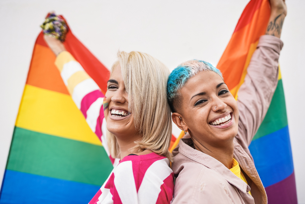 A couple celebrating Pride with rainbow flags