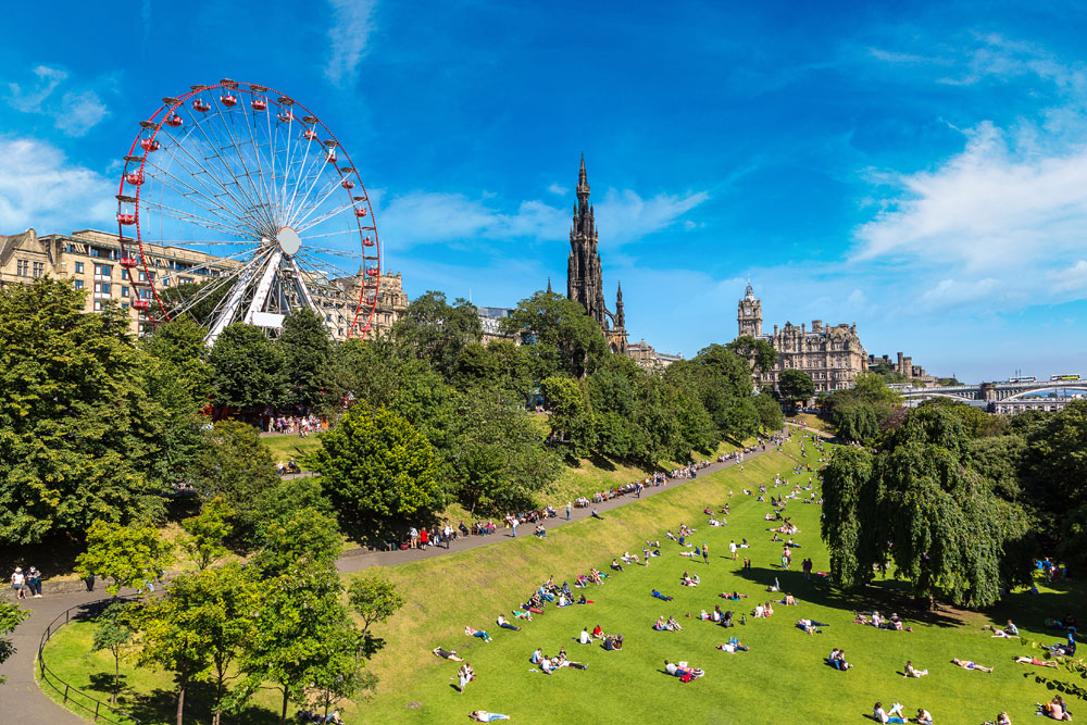 Princes Street Gardens Edinburgh in the summer, with the Festival Wheel and Scott Monument