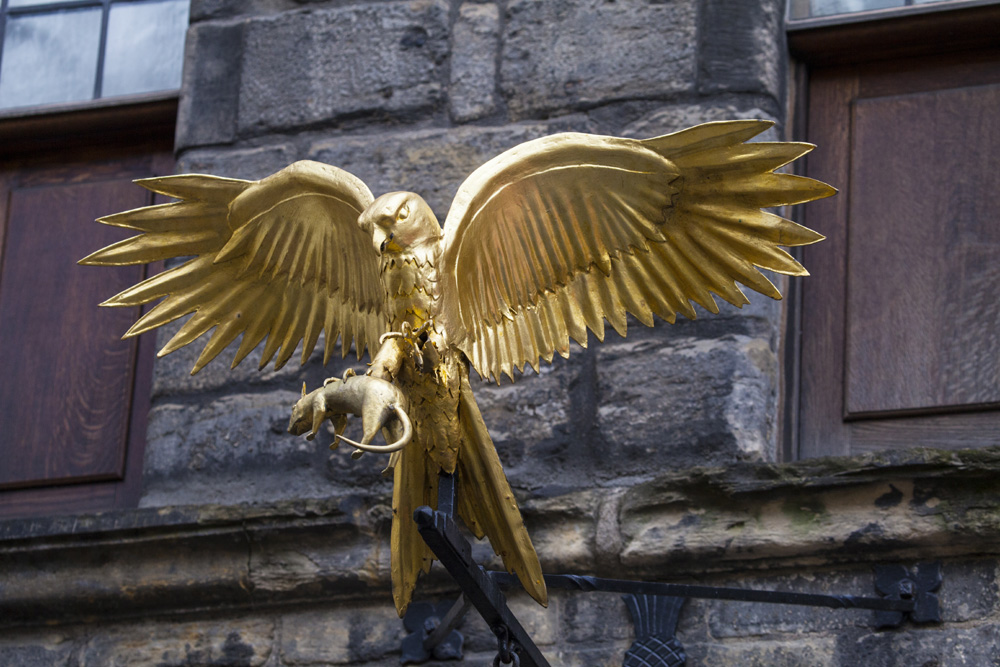 Golden sculpture of a bird outside Gladstone's Land in Edinburgh