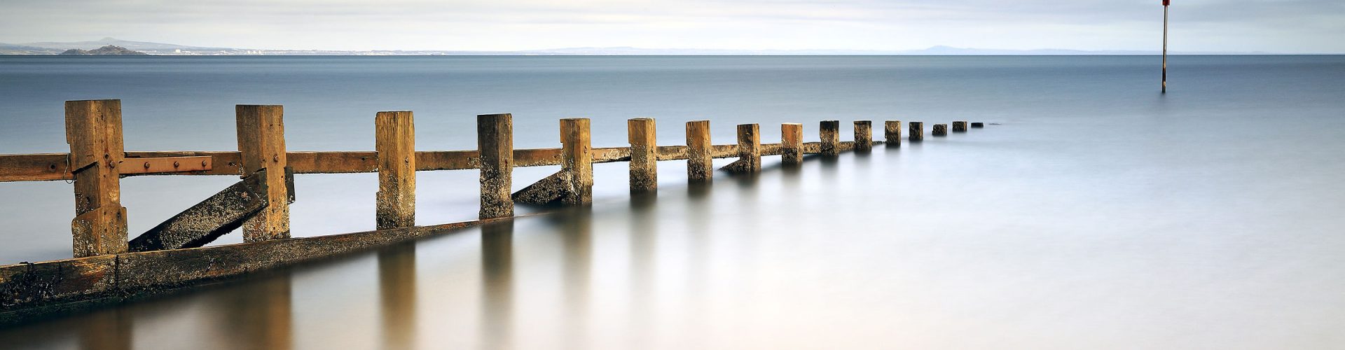 Wooden groynes leading in to the water at Portobello